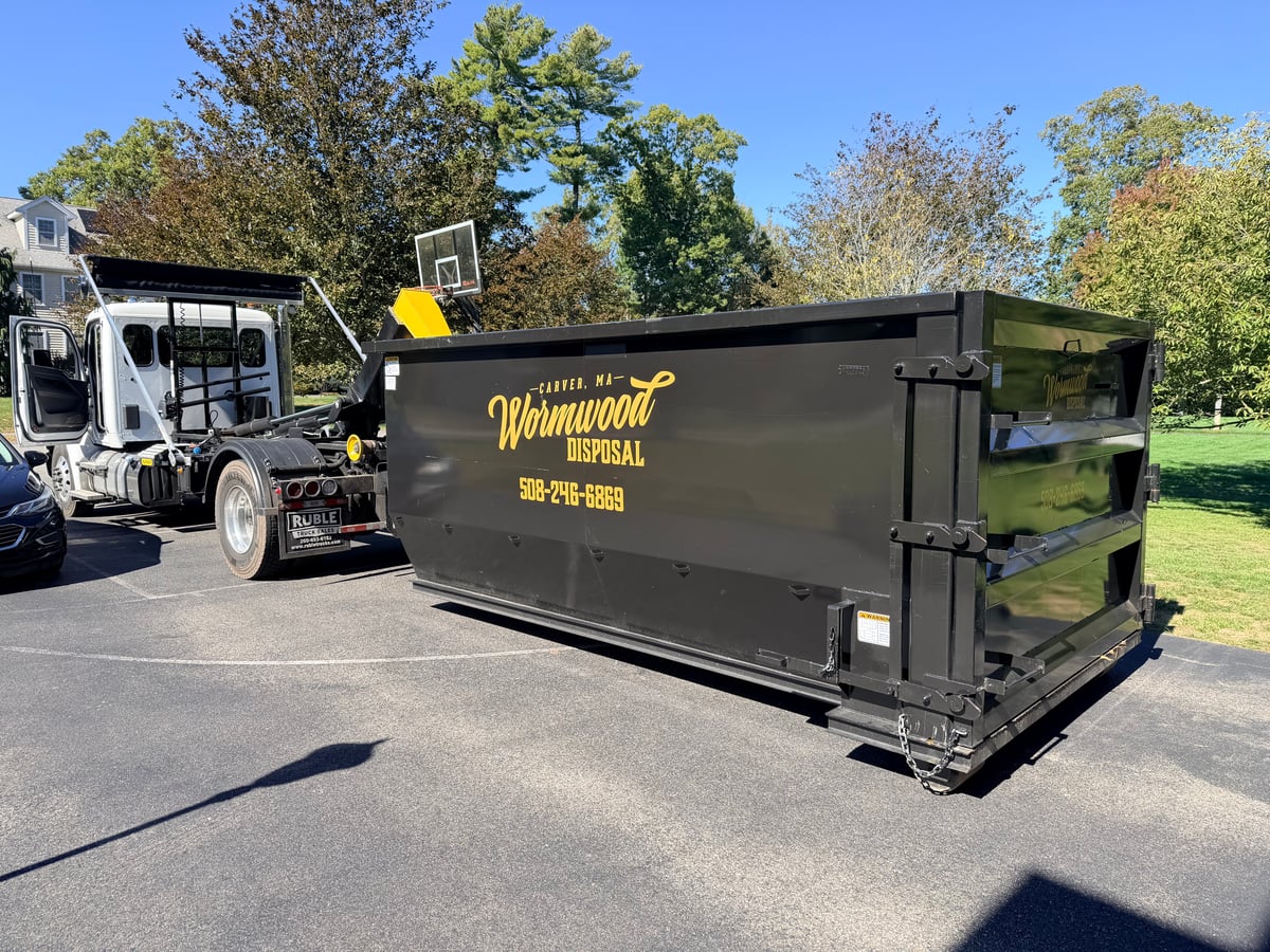 Wormwood Disposal truck delivering dumpster