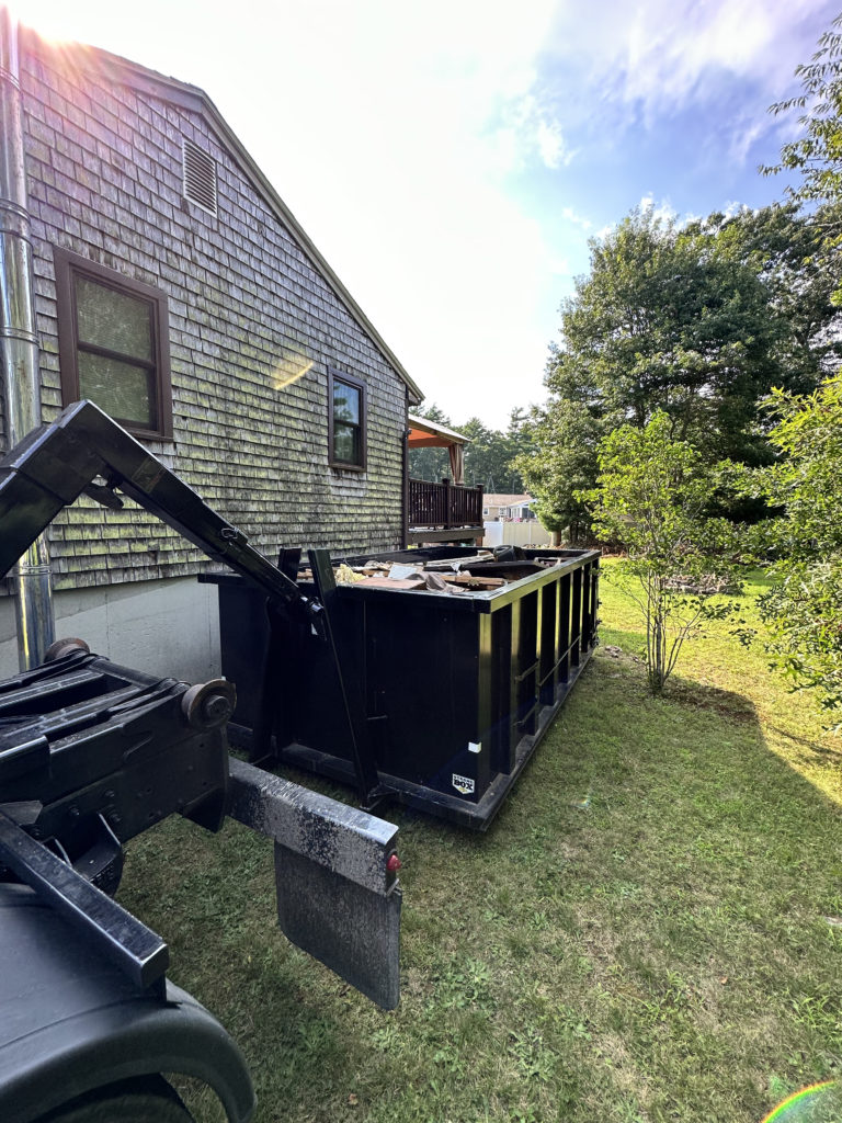 15 Yard Dumpster placed on the side of a house in Carver, Ma