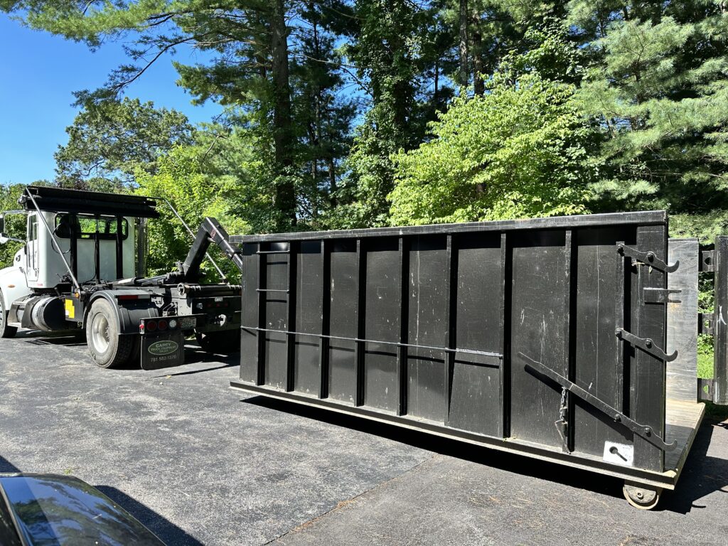 Unloading a 20 Yard dumpster in a driveway in Taunton