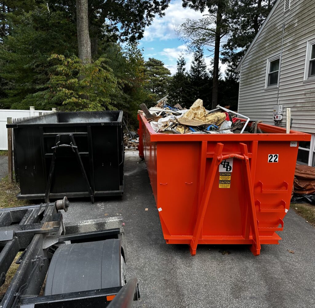 two dumpsters in a driveway in Plymouth Ma