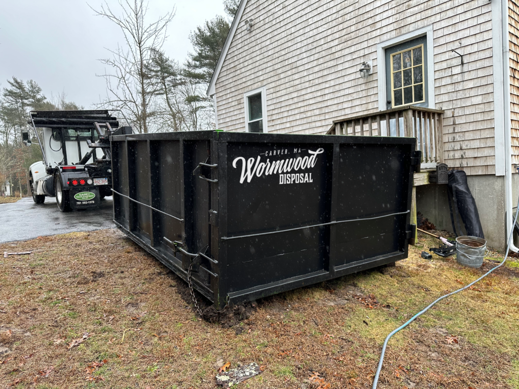 Black Wormwood Disposal 12 Yard Dumpster in a driveway in Middleboro